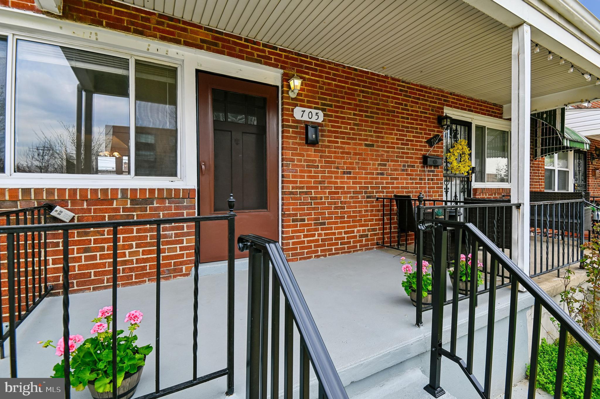 705 Tolna Street Baltimore, MD 21224 - Photo 25 of 34 a view of a house with large windows and flower plants