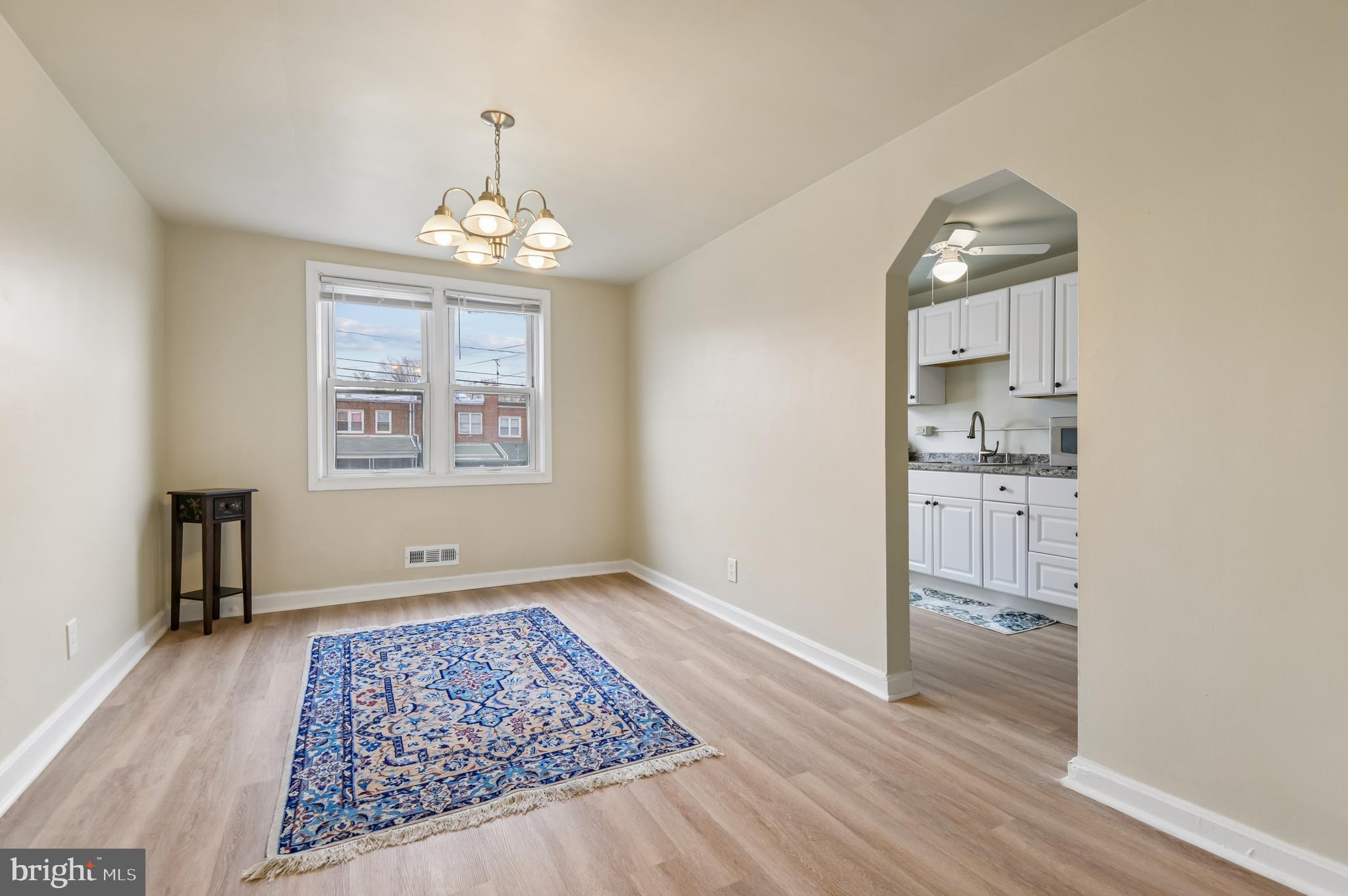 705 Tolna Street Baltimore, MD 21224 - Photo 4 of 34 wooden floor in an empty room with a window