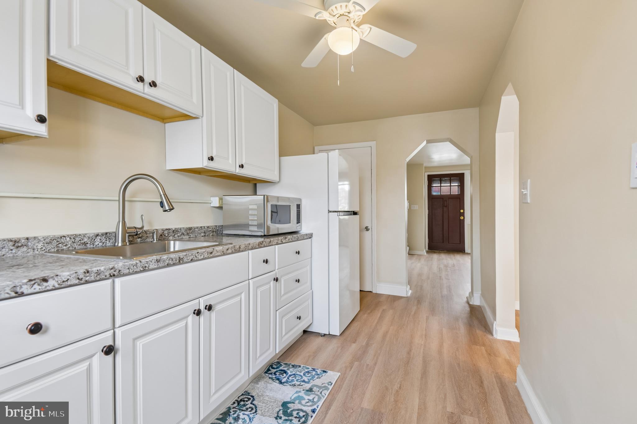 705 Tolna Street Baltimore, MD 21224 - Photo 6 of 34 a kitchen with granite countertop a sink cabinets stainless steel appliances and a counter space