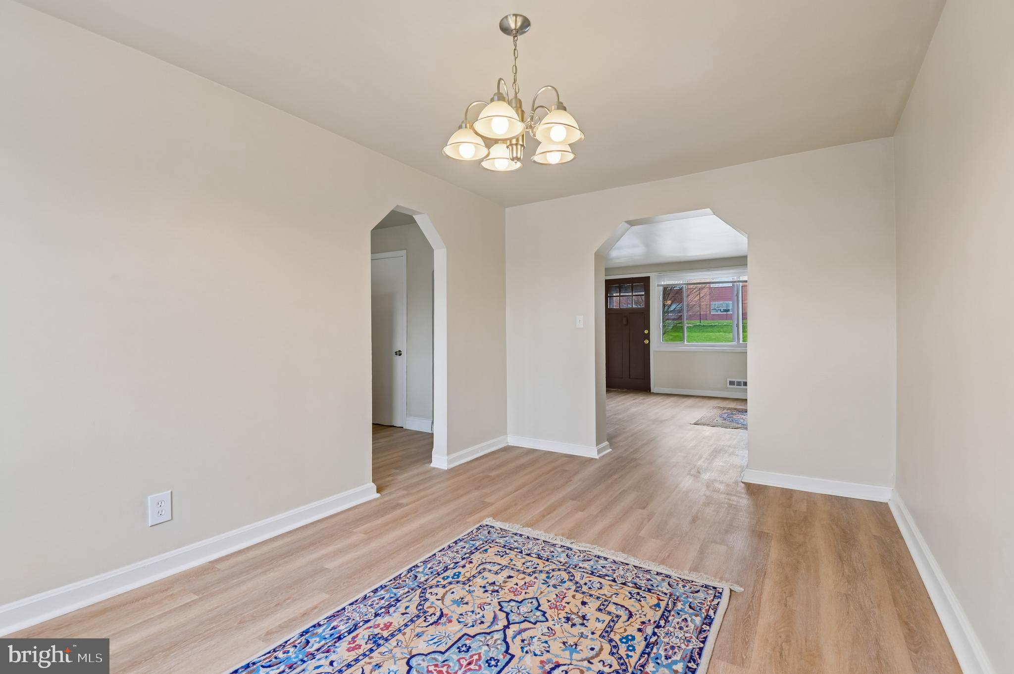 705 Tolna Street Baltimore, MD 21224 - Photo 8 of 34 wooden floor in an empty room with a window