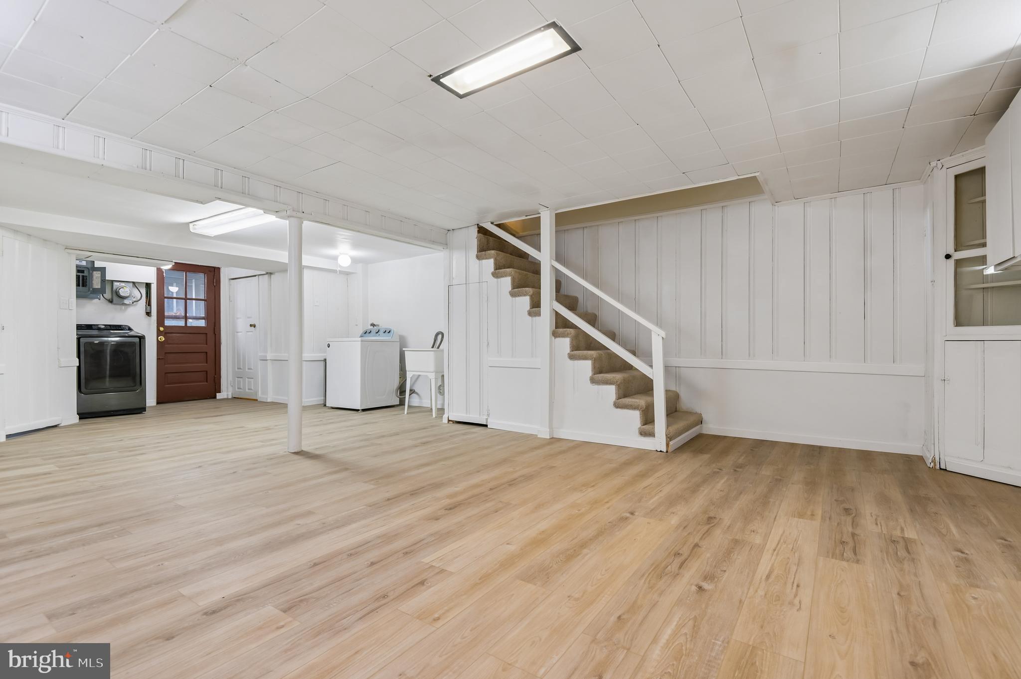 705 Tolna Street Baltimore, MD 21224 - Photo 10 of 34 a view of an empty room with wooden floor and stairs