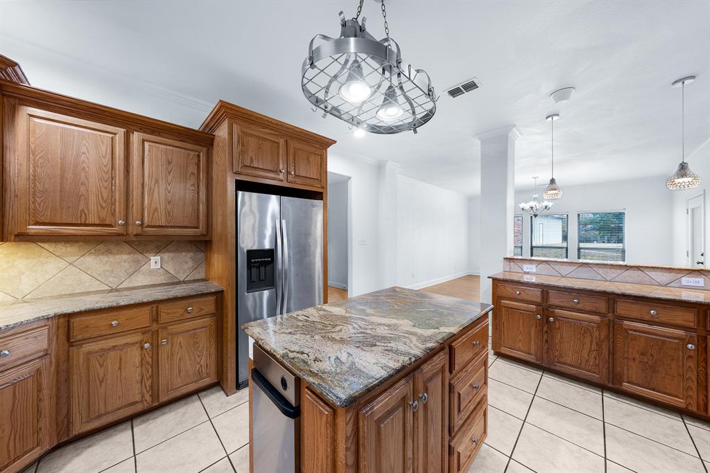 10471 Holly Creek Road Terrell, TX 75160 - Photo 13 of 40 a kitchen with granite countertop cabinets and chandelier