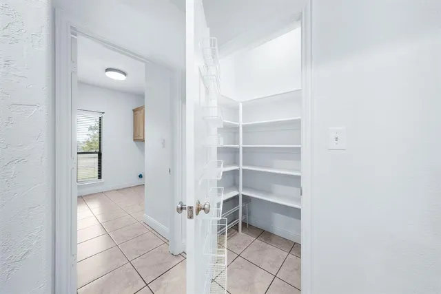 a view of an empty room with a closet