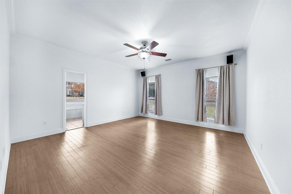 10471 Holly Creek Road Terrell, TX 75160 - Photo 19 of 40 a view of an empty room with a window and wooden floor