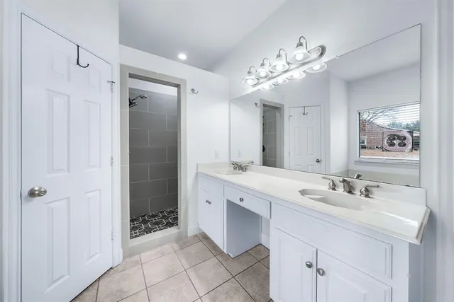 a spacious bathroom with a sink double vanity and a mirror