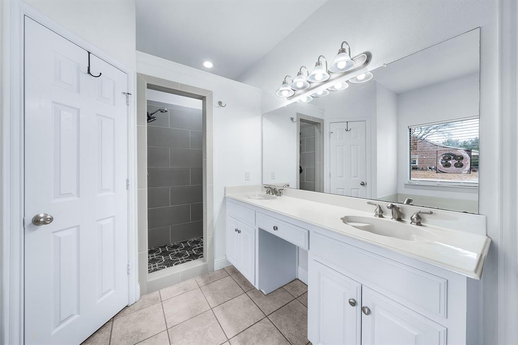 10471 Holly Creek Road Terrell, TX 75160 - Photo 22 of 40 a spacious bathroom with a sink double vanity and a mirror