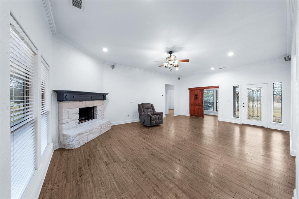 10471 Holly Creek Road Terrell, TX 75160 - Photo 5 of 40 a view of a livingroom with fireplace wooden floor and windows