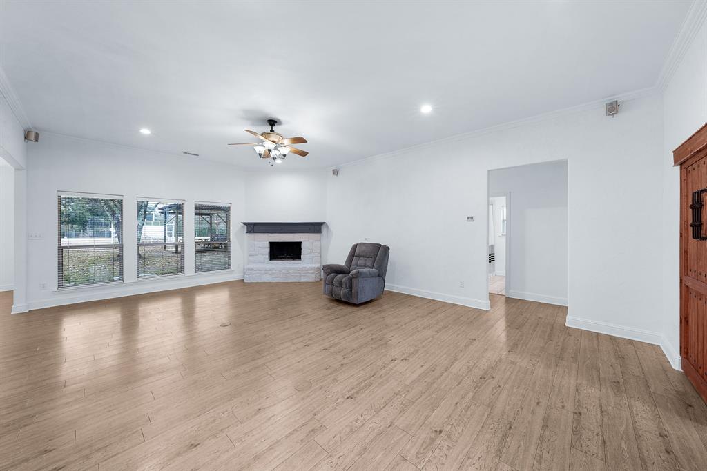 10471 Holly Creek Road Terrell, TX 75160 - Photo 6 of 40 a view of an empty room with window and wooden floor