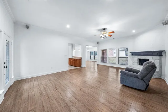 a view of livingroom with furniture wooden floor chandelier and windows