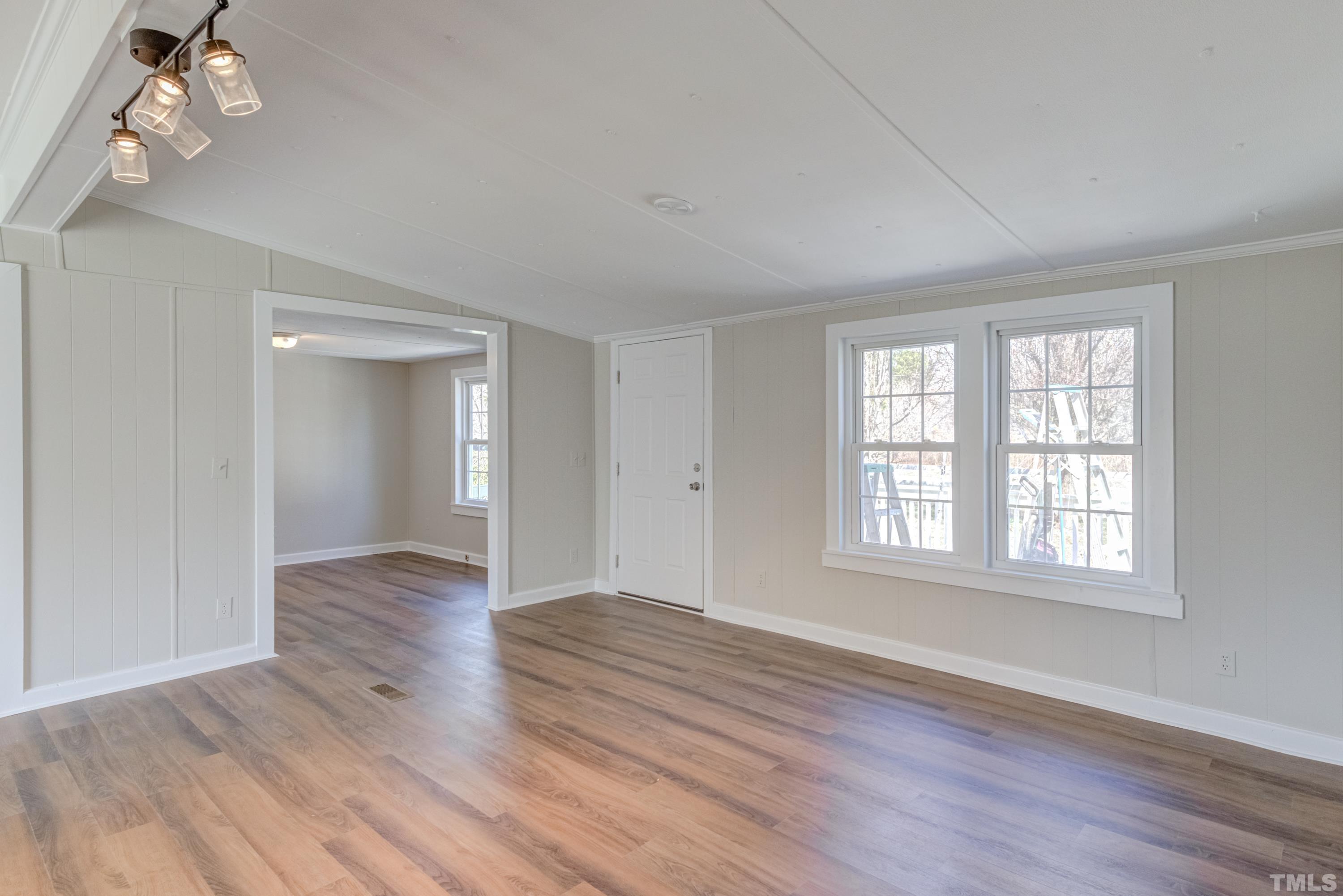 807 Lipscomb Road Angier, NC 27501 - Photo 34 of 39 a view of an empty room with wooden floor and a window