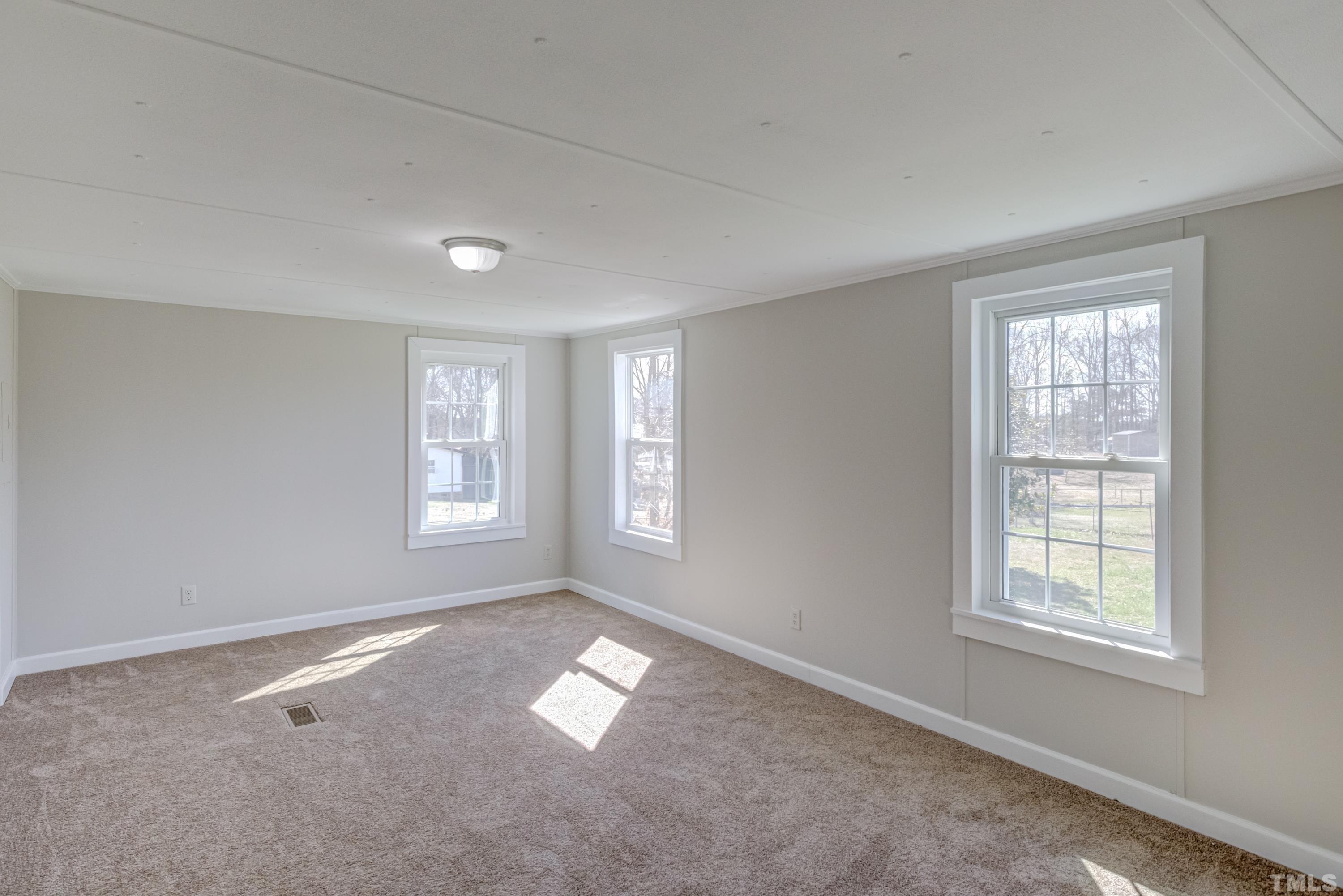 807 Lipscomb Road Angier, NC 27501 - Photo 10 of 39 a view of empty room with windows