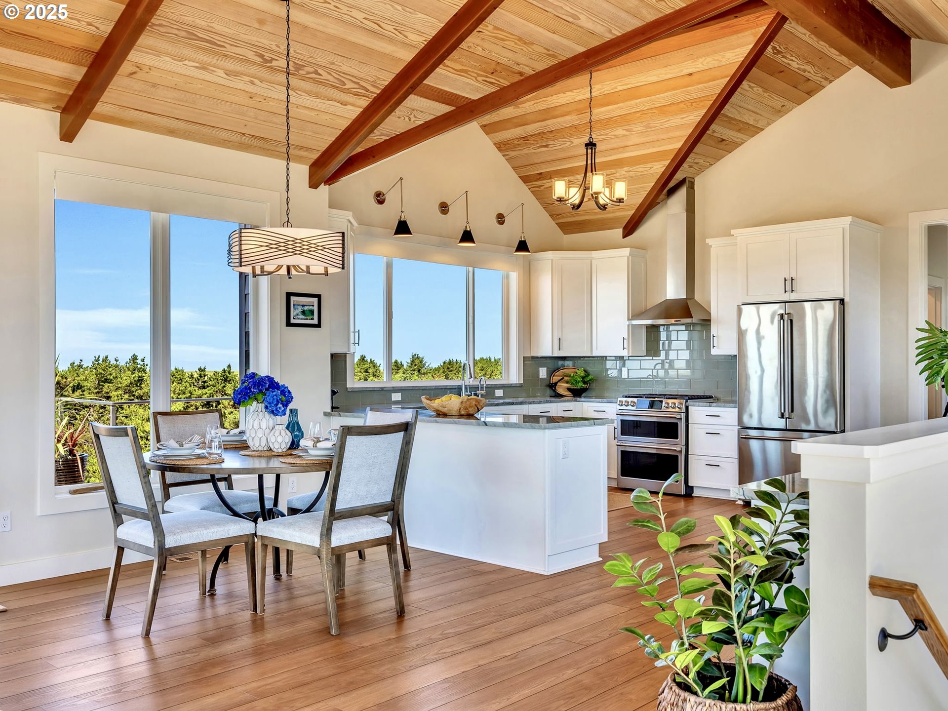 90043 Ocean Drive Warrenton, OR 97146 - Photo 18 of 48 a kitchen with stainless steel appliances granite countertop a table chairs and a refrigerator