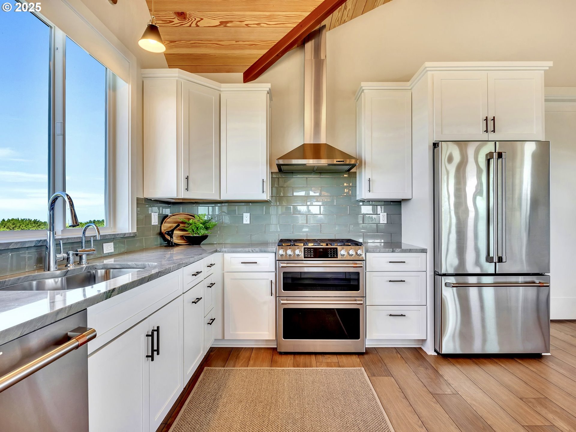 90043 Ocean Drive Warrenton, OR 97146 - Photo 21 of 48 a kitchen with stainless steel appliances a stove a sink and a refrigerator