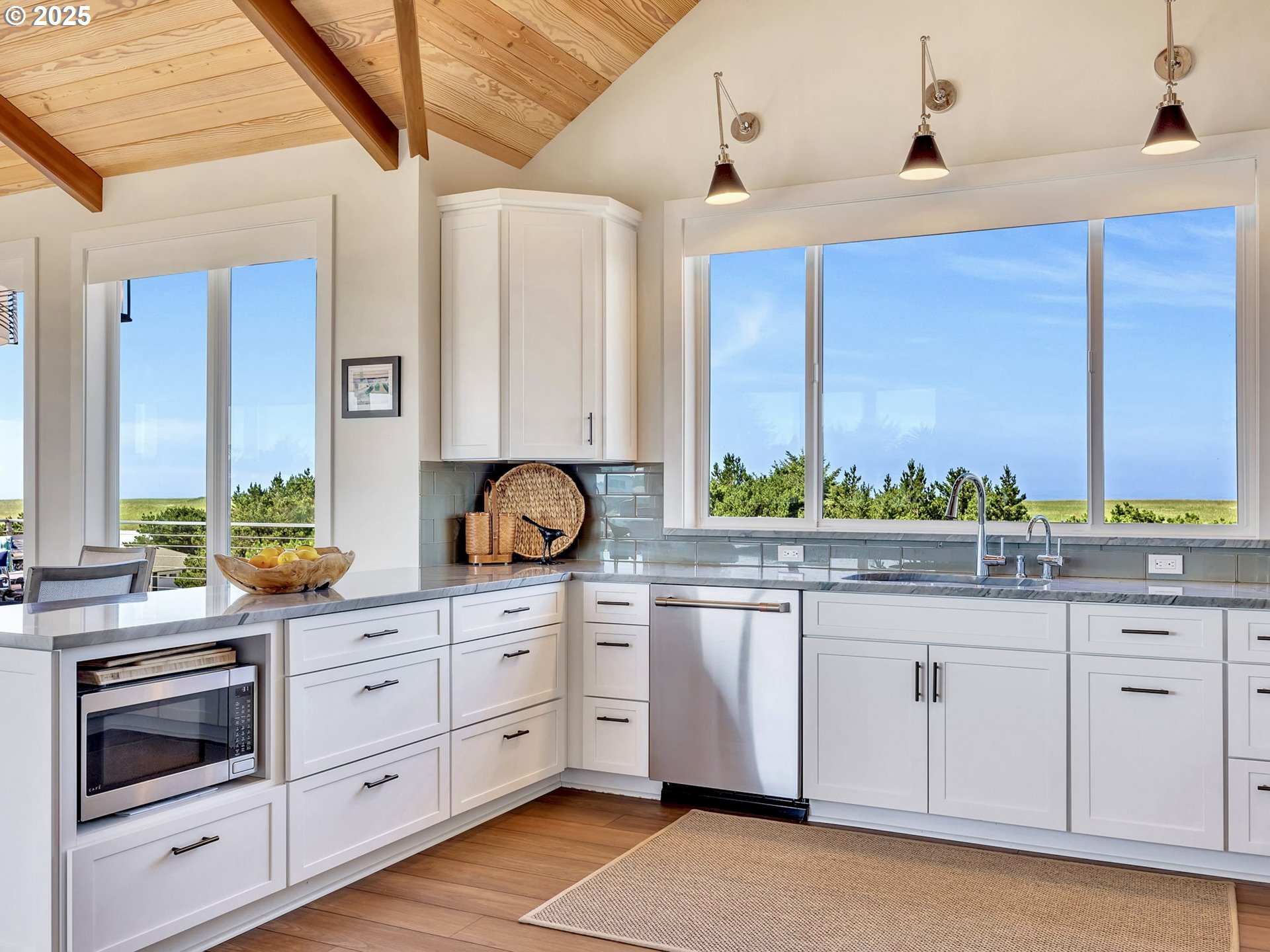 90043 Ocean Drive Warrenton, OR 97146 - Photo 22 of 48 a kitchen with stainless steel appliances granite countertop a stove a sink and a microwave