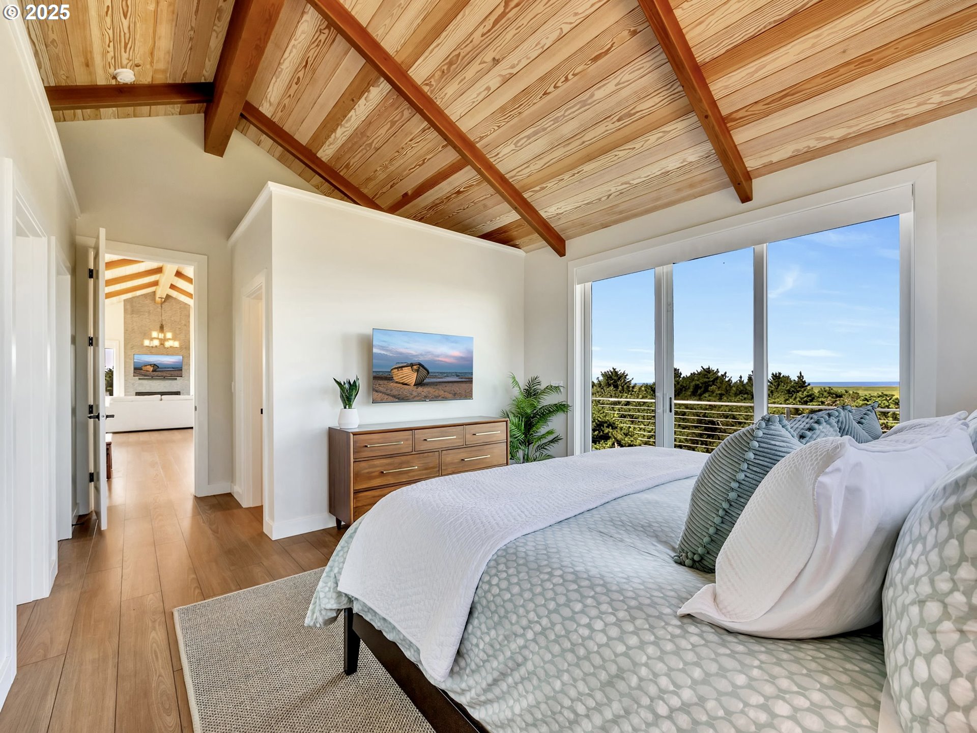 90043 Ocean Drive Warrenton, OR 97146 - Photo 28 of 48 a bedroom with a large bed and a balcony