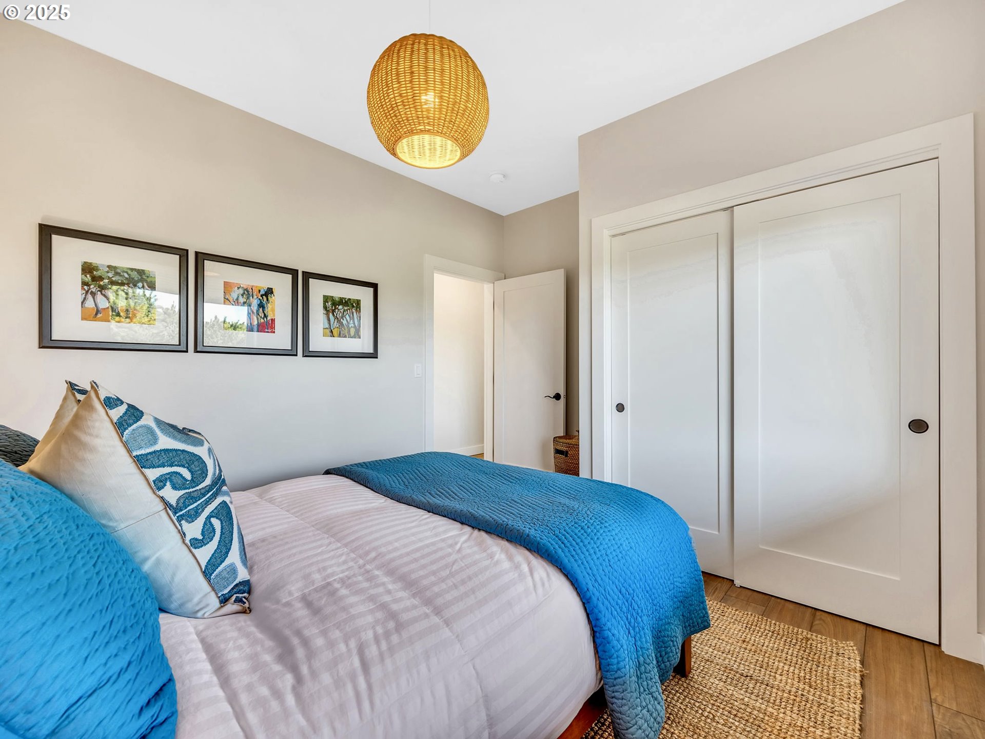 90043 Ocean Drive Warrenton, OR 97146 - Photo 35 of 48 a bedroom with a bed and painting on the wall