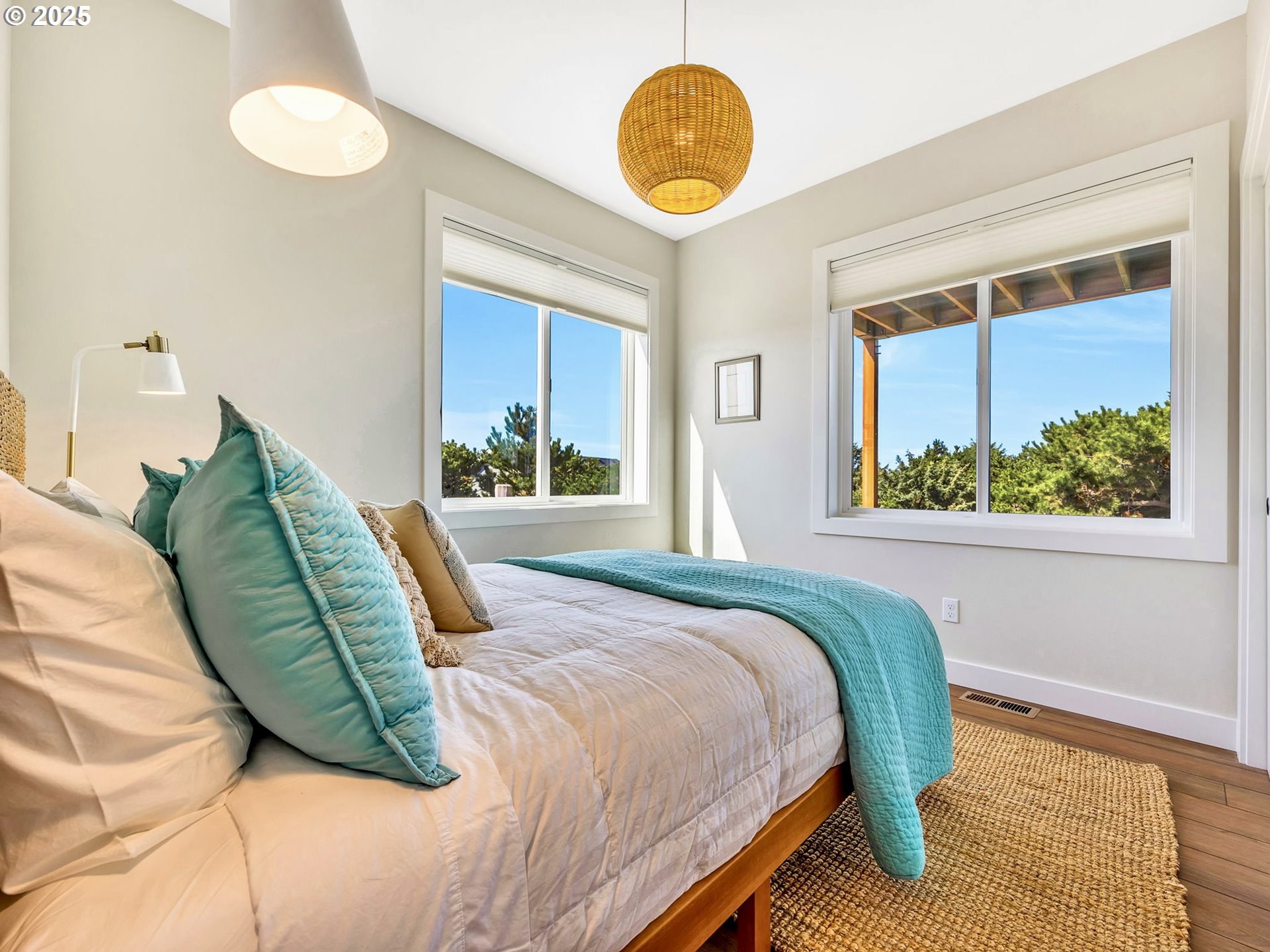 90043 Ocean Drive Warrenton, OR 97146 - Photo 38 of 48 a bedroom with a bed mirror and window