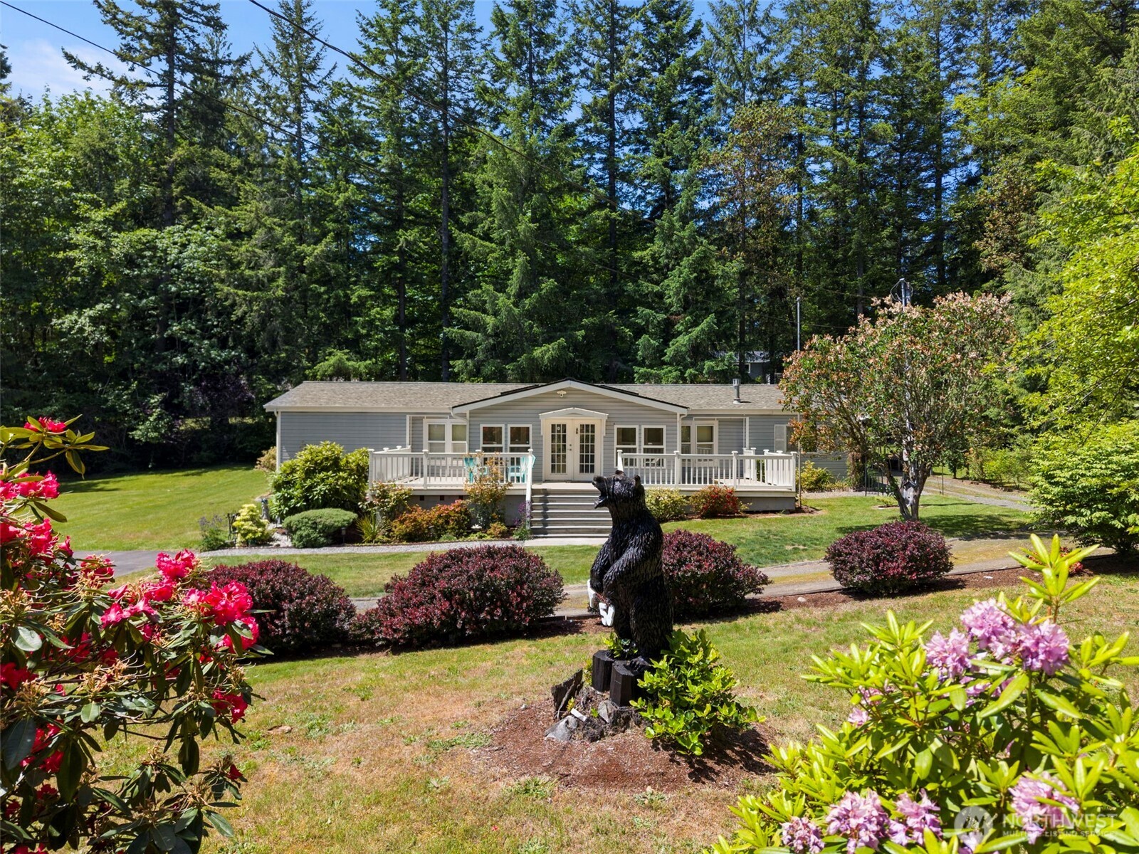 3758 Aiken Road Southeast Port Orchard, WA 98366 - Photo 1 of 40 a front view of a house with a yard and fountain