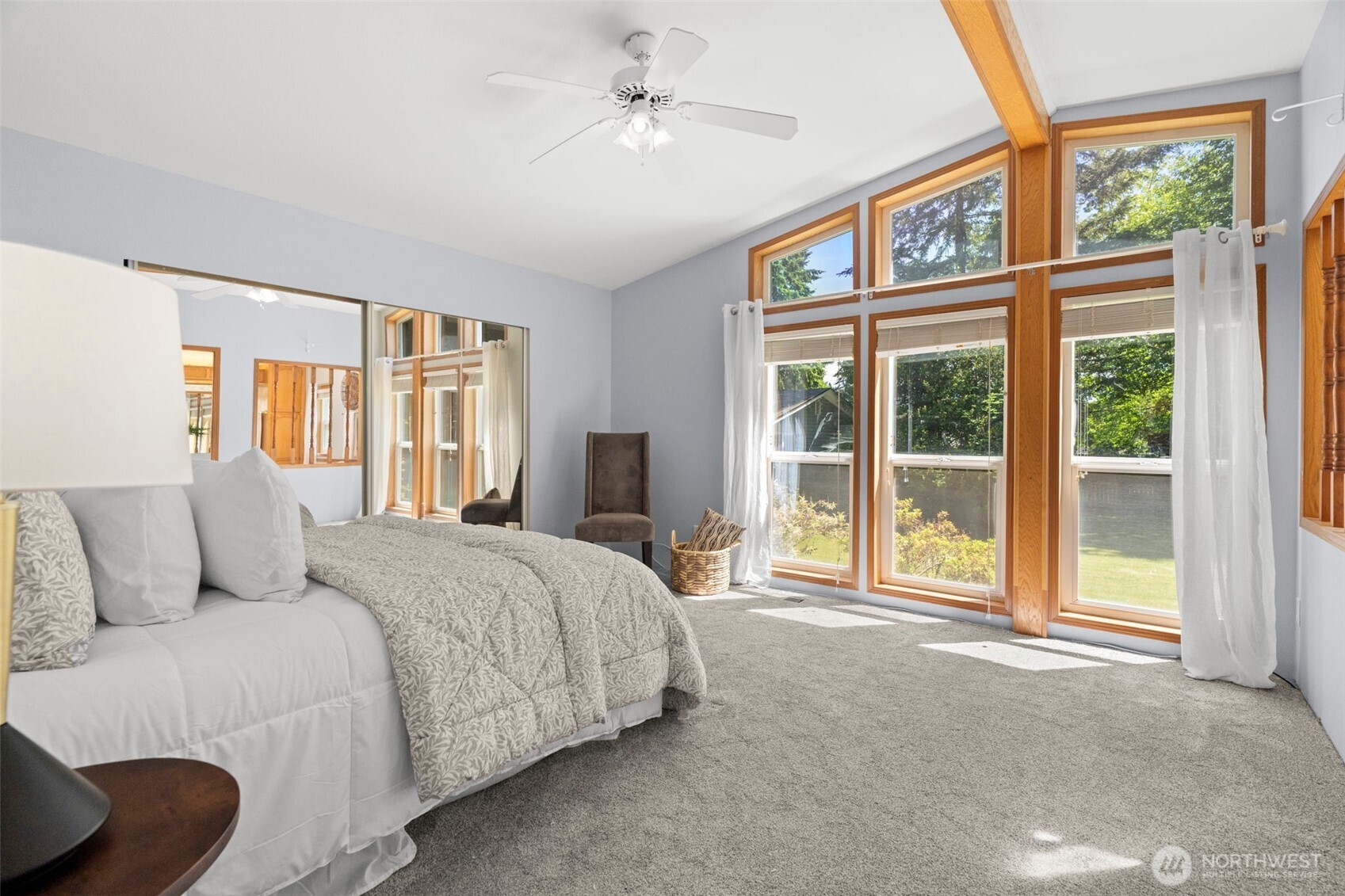 3758 Aiken Road Southeast Port Orchard, WA 98366 - Photo 19 of 40 a bedroom with a large bed and a large window