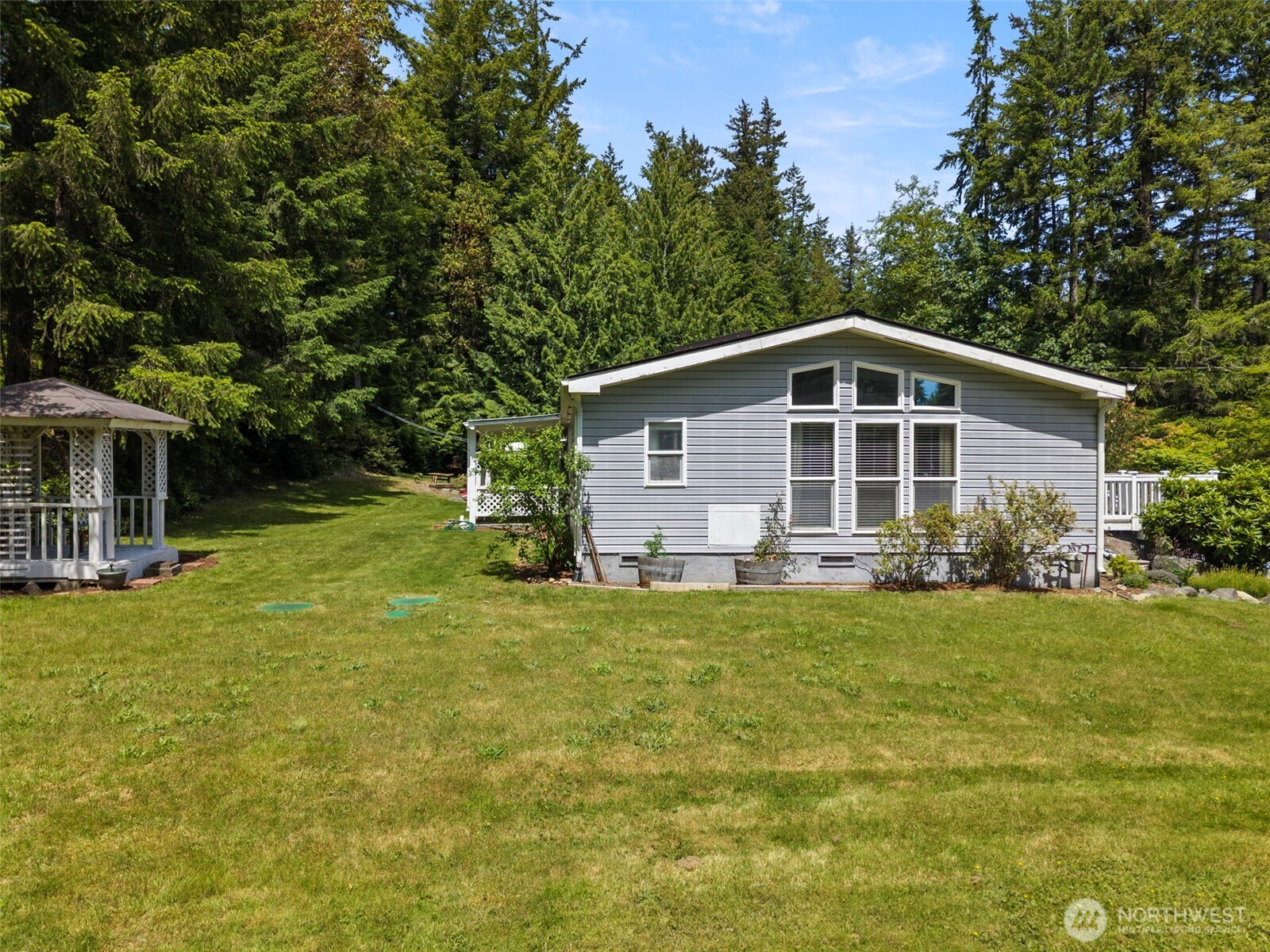 3758 Aiken Road Southeast Port Orchard, WA 98366 - Photo 31 of 40 a view of a house with backyard