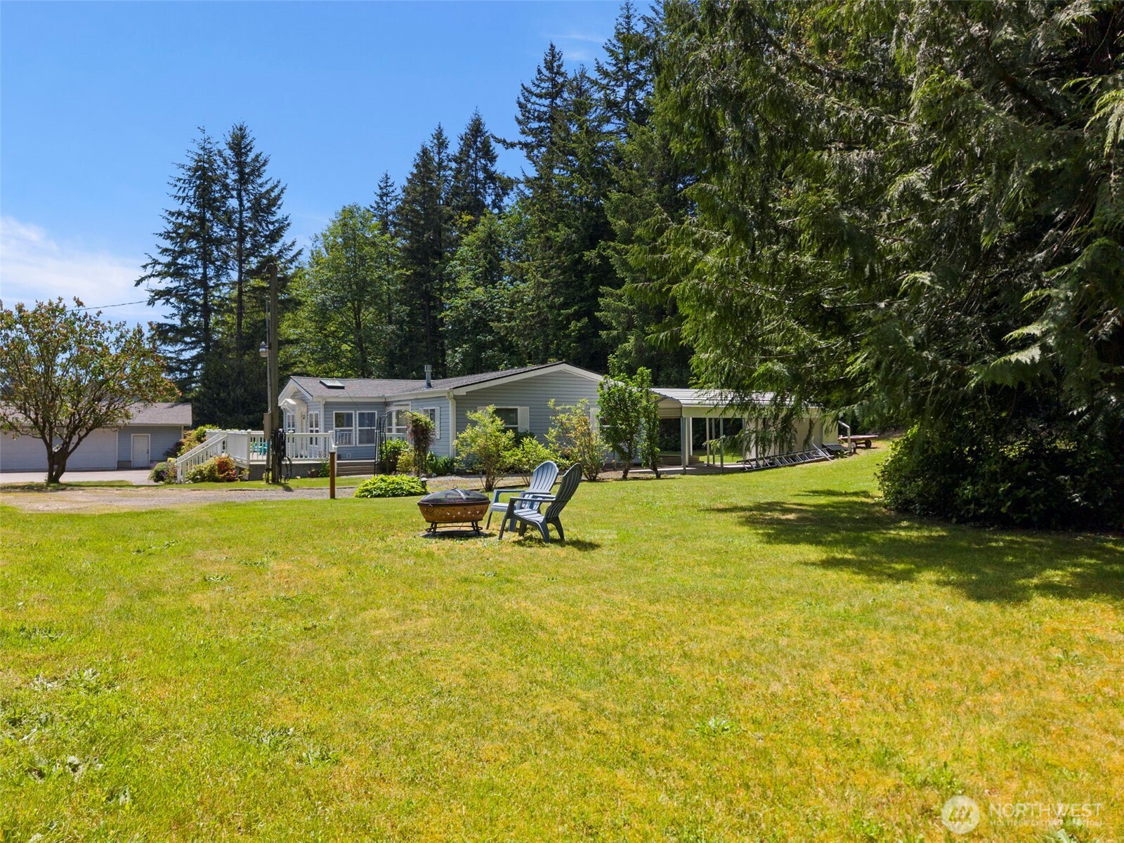 3758 Aiken Road Southeast Port Orchard, WA 98366 - Photo 34 of 40 a view of a swimming pool with lawn chairs and a yard