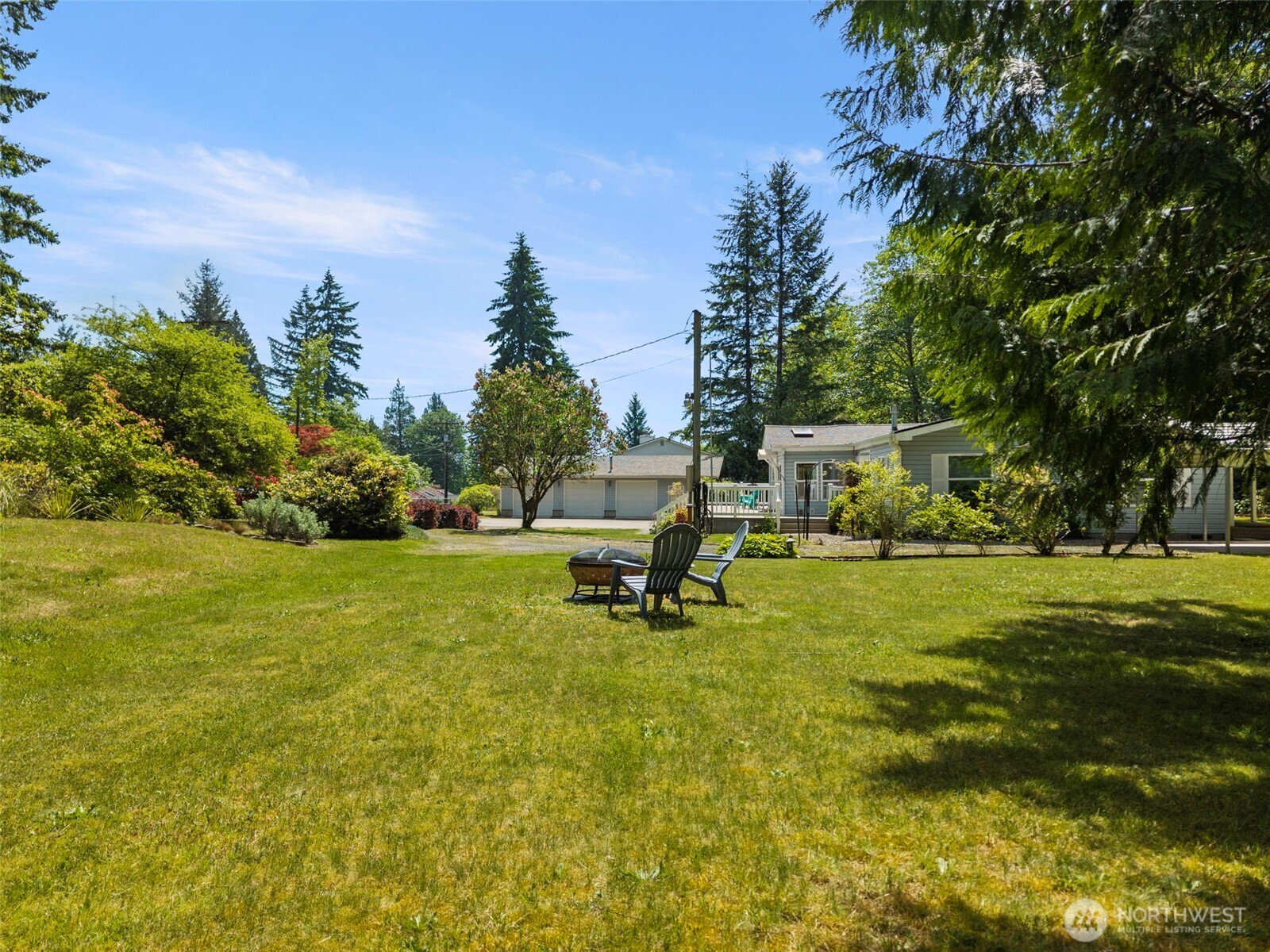 3758 Aiken Road Southeast Port Orchard, WA 98366 - Photo 35 of 40 a view of a swimming pool with lawn chairs and plants
