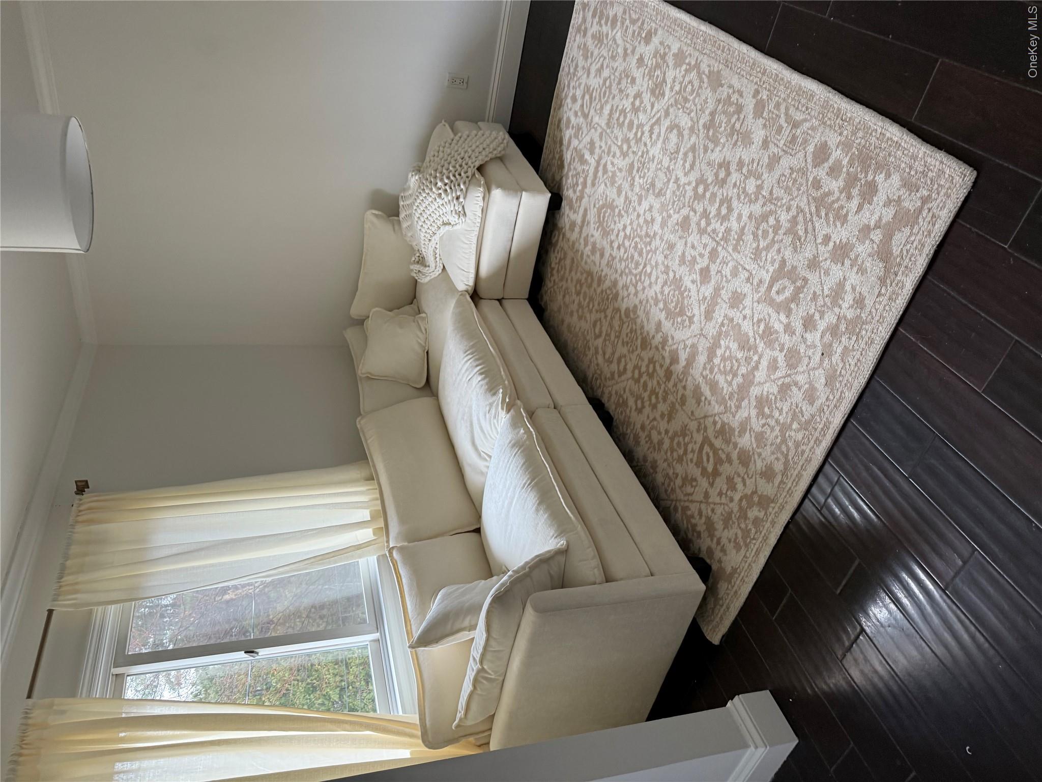29 Wilton Road Rye Brook, NY 10573 - Photo 6 of 18 Living area with baseboards, dark wood-type flooring, and ornamental molding