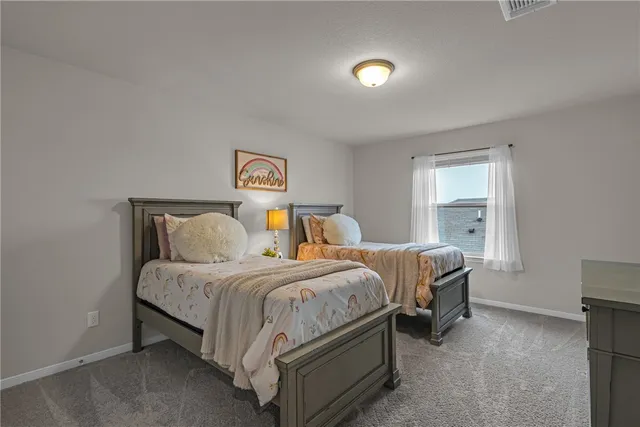 a bedroom with two beds and a window