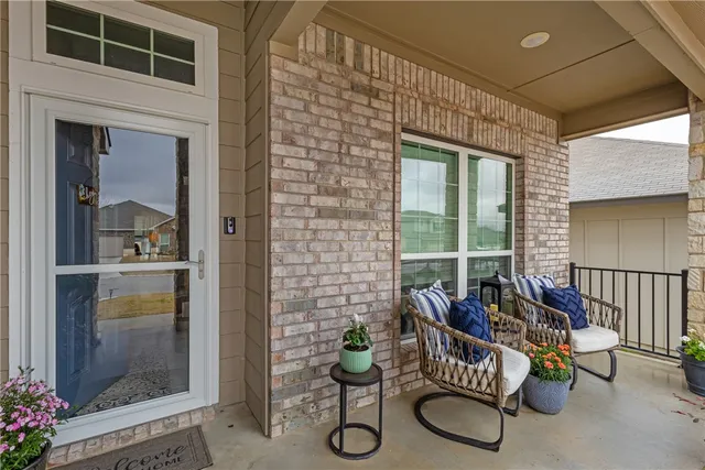 a balcony with furniture and potted plant