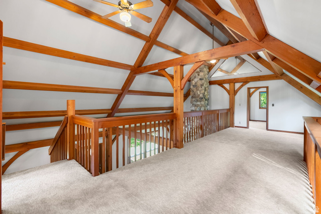 435 Canyon Road Millville, UT 84326 - Photo 26 of 113 Open loft area featuring exposed timber beams, vaulted ceiling, and light-toned carpeting
