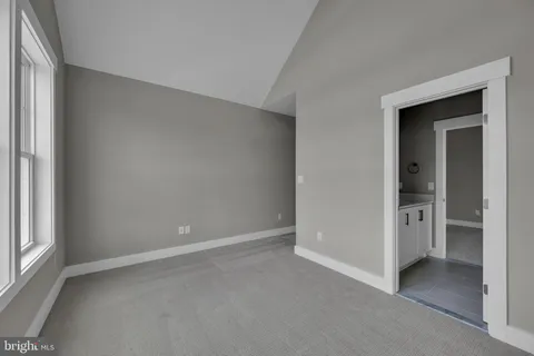 an empty room with closet and a window