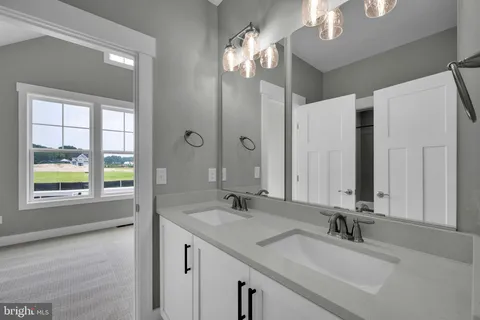 a bathroom with a double vanity sink and a mirror