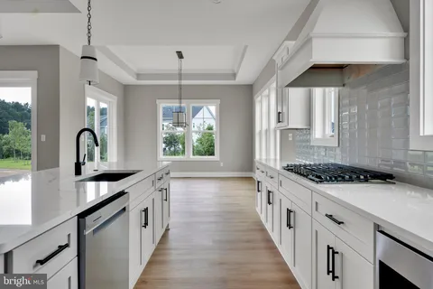 a kitchen with stainless steel appliances a sink stove and cabinets