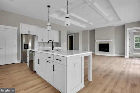 a kitchen with stainless steel appliances a stove top oven and refrigerator