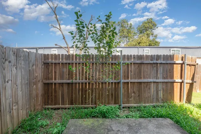 a view of a backyard with a wooden fence