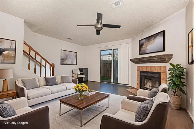 a living room with furniture fireplace and flat screen tv
