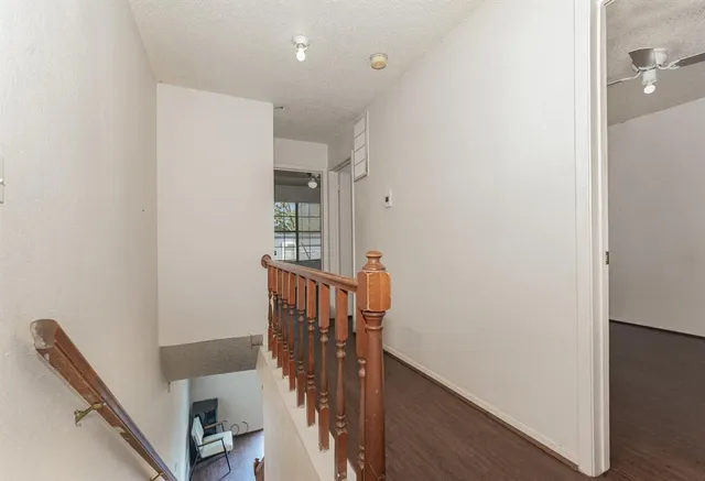 a view of a hallway with windows and stairs