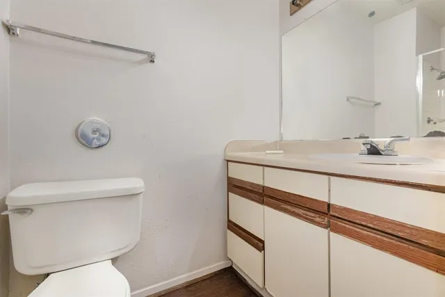 a bathroom with a toilet sink and mirror