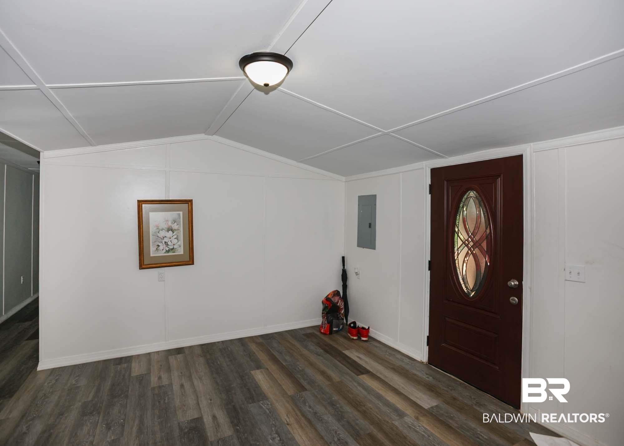 11998 Workman Avenue Foley, AL 36535 - Photo 15 of 59 Additional living space featuring wood finished floors, vaulted ceiling, and electric panel