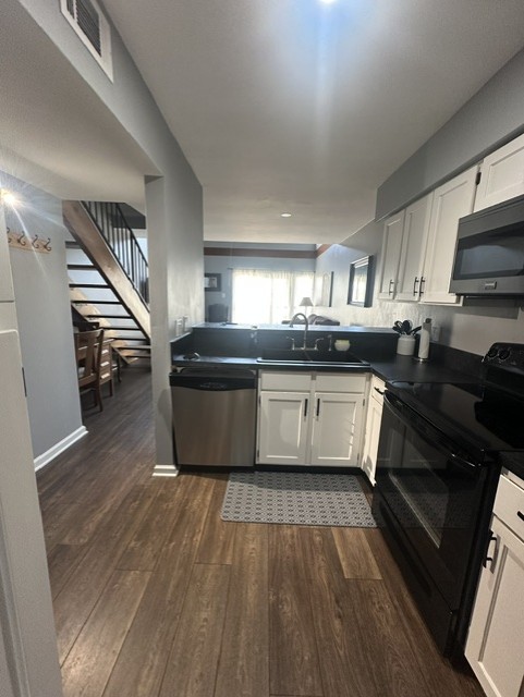 2215 Post Road, Unit 2044 Austin, TX 78704 - Photo 11 of 34 Gleaming hardwood floors and classic cabinetry anchor this thoughtfully designed kitchen space.