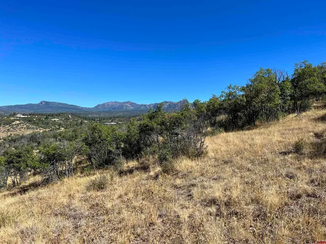 a view of a large mountain with mountains in the background