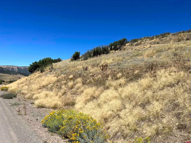 a view of a mountain with a yard