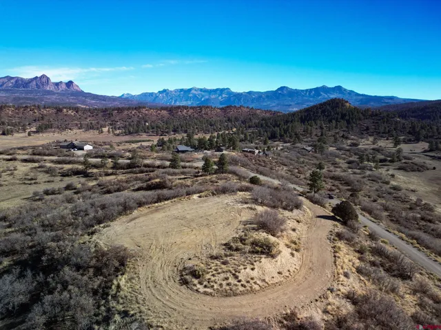 a view of a mountain with a field