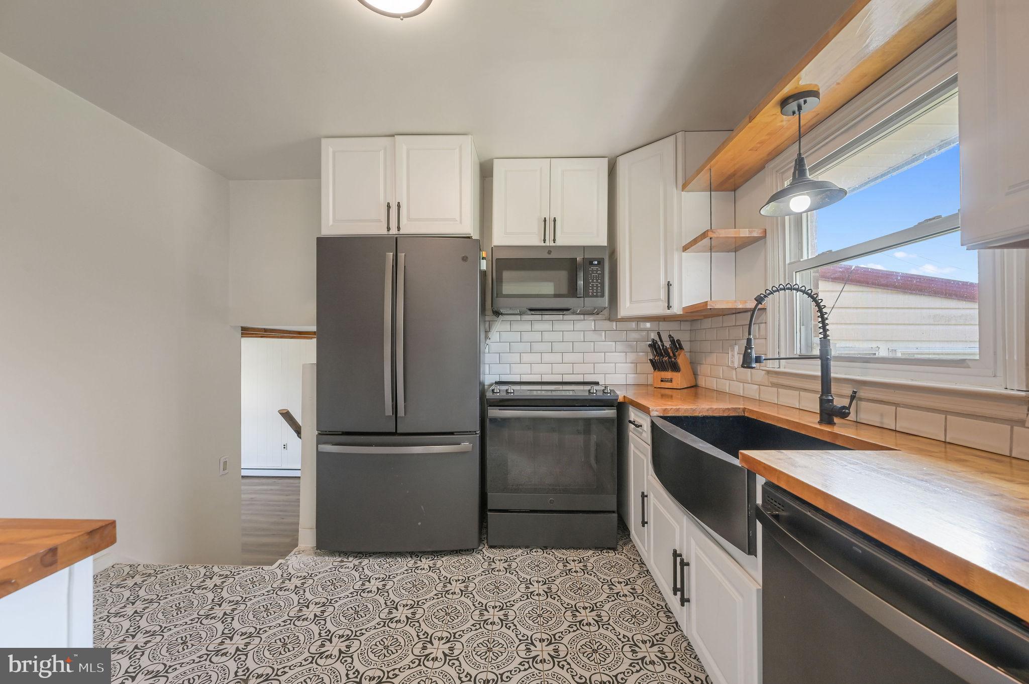 908 South Cass Street Middletown, DE 19709 - Photo 15 of 28 a kitchen with a sink stove and refrigerator