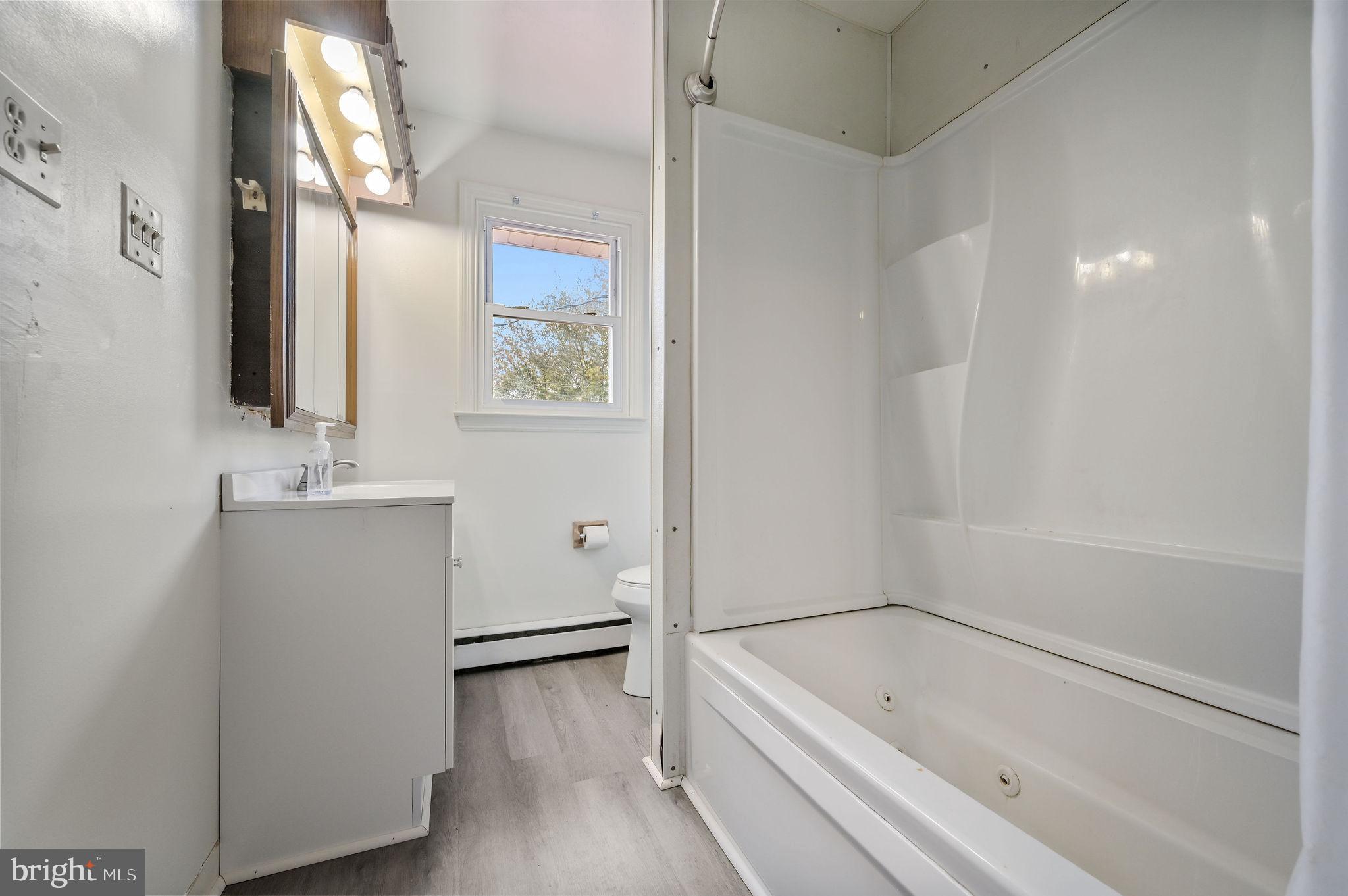 908 South Cass Street Middletown, DE 19709 - Photo 18 of 28 a bathroom with a tub sink and mirror