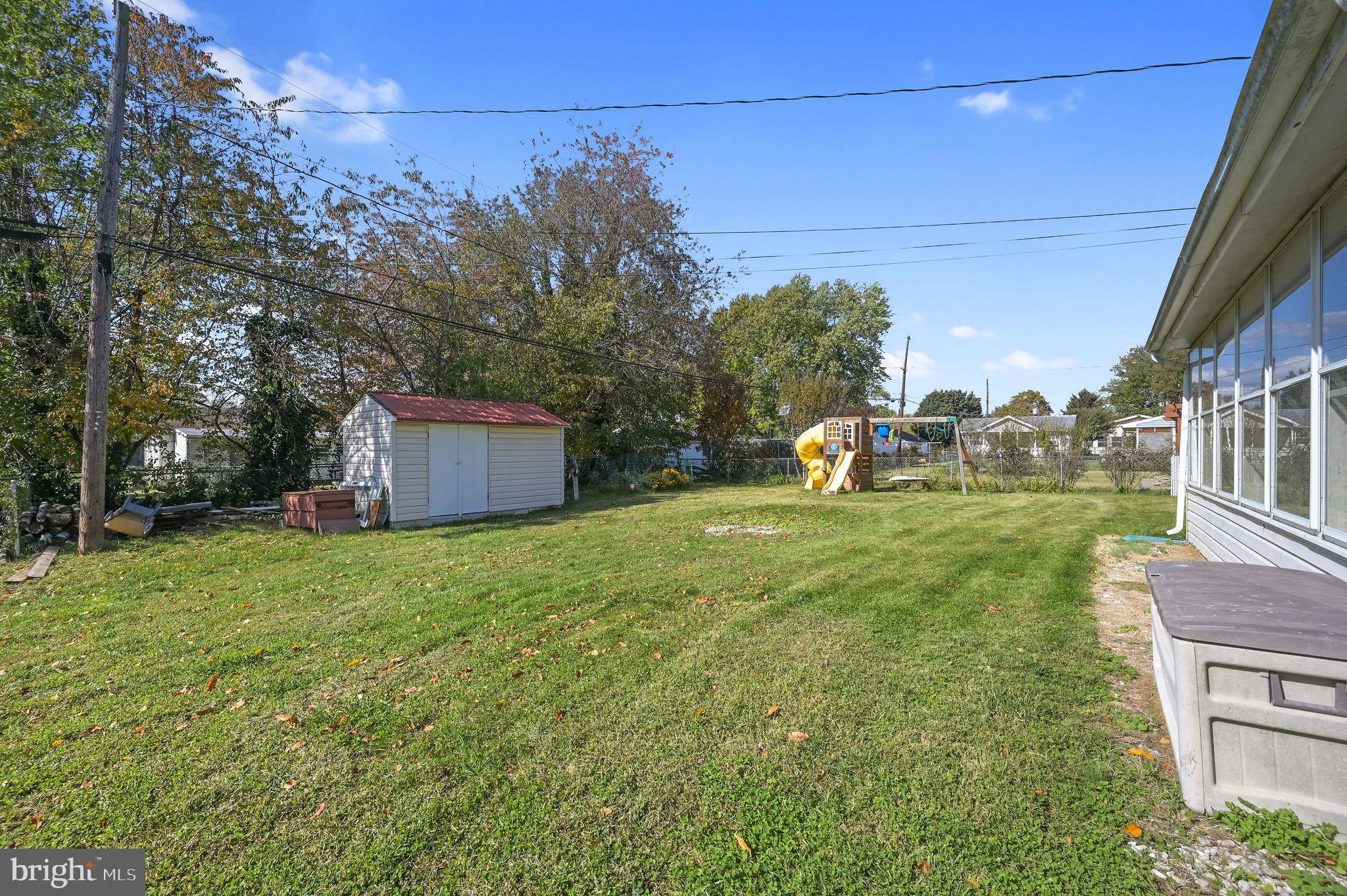 908 South Cass Street Middletown, DE 19709 - Photo 4 of 28 a backyard of a house with lots of green space