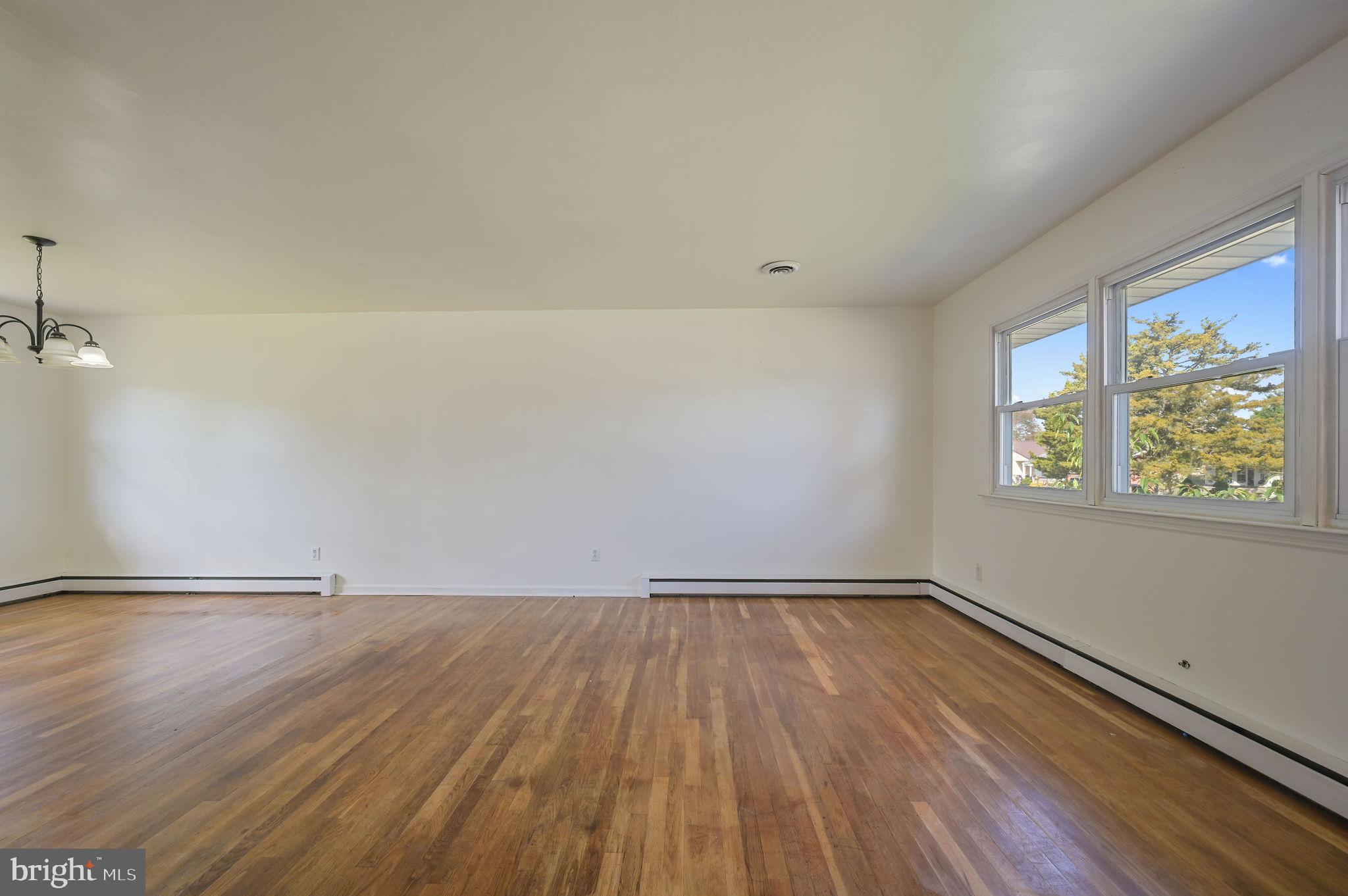 908 South Cass Street Middletown, DE 19709 - Photo 7 of 28 a view of an empty room with wooden floor and a window