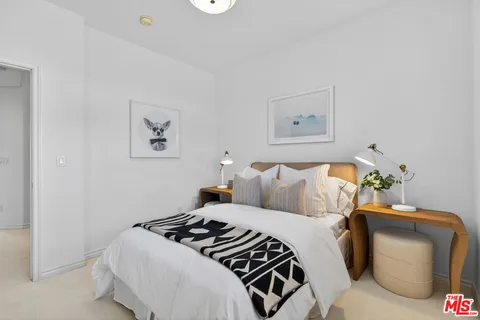 a bedroom with a bed and lamp