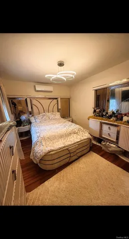 a view of a bedroom with furniture and window