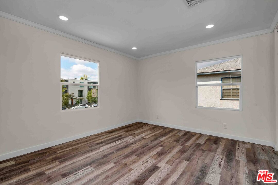 11575 Riverside Drive Valley Village, CA 91602 - Photo 13 of 16 a room with a wooden floor and a window